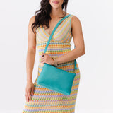 Seafoam Large | Model holding a zip top crossbody bag with detachable strap