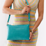Seafoam Large | Model holding a zip top crossbody bag with detachable strap