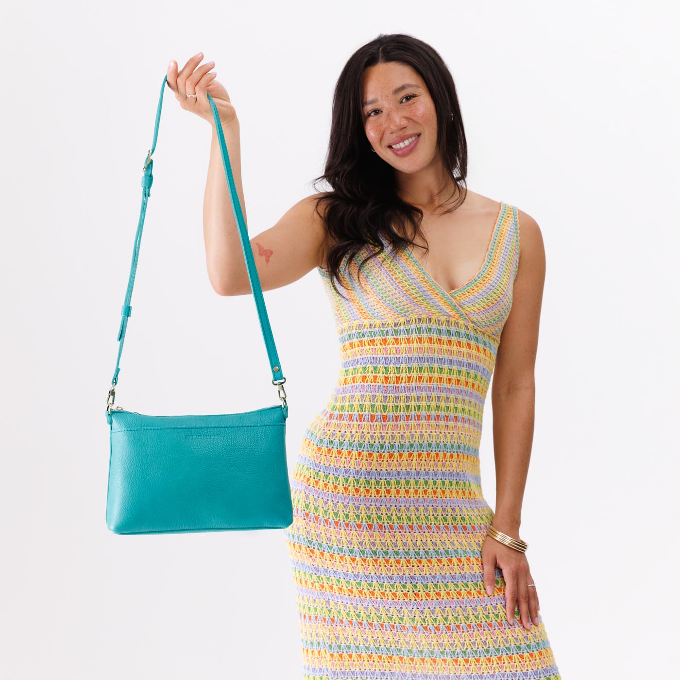Seafoam*Large | Model holding a zip top crossbody bag with detachable strap