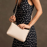Pebbled Bone Classic | Model wearing a zip top petite crossbody bag with detachable strap