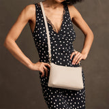 Pebbled Bone Classic | Model wearing a zip top petite crossbody bag with detachable strap