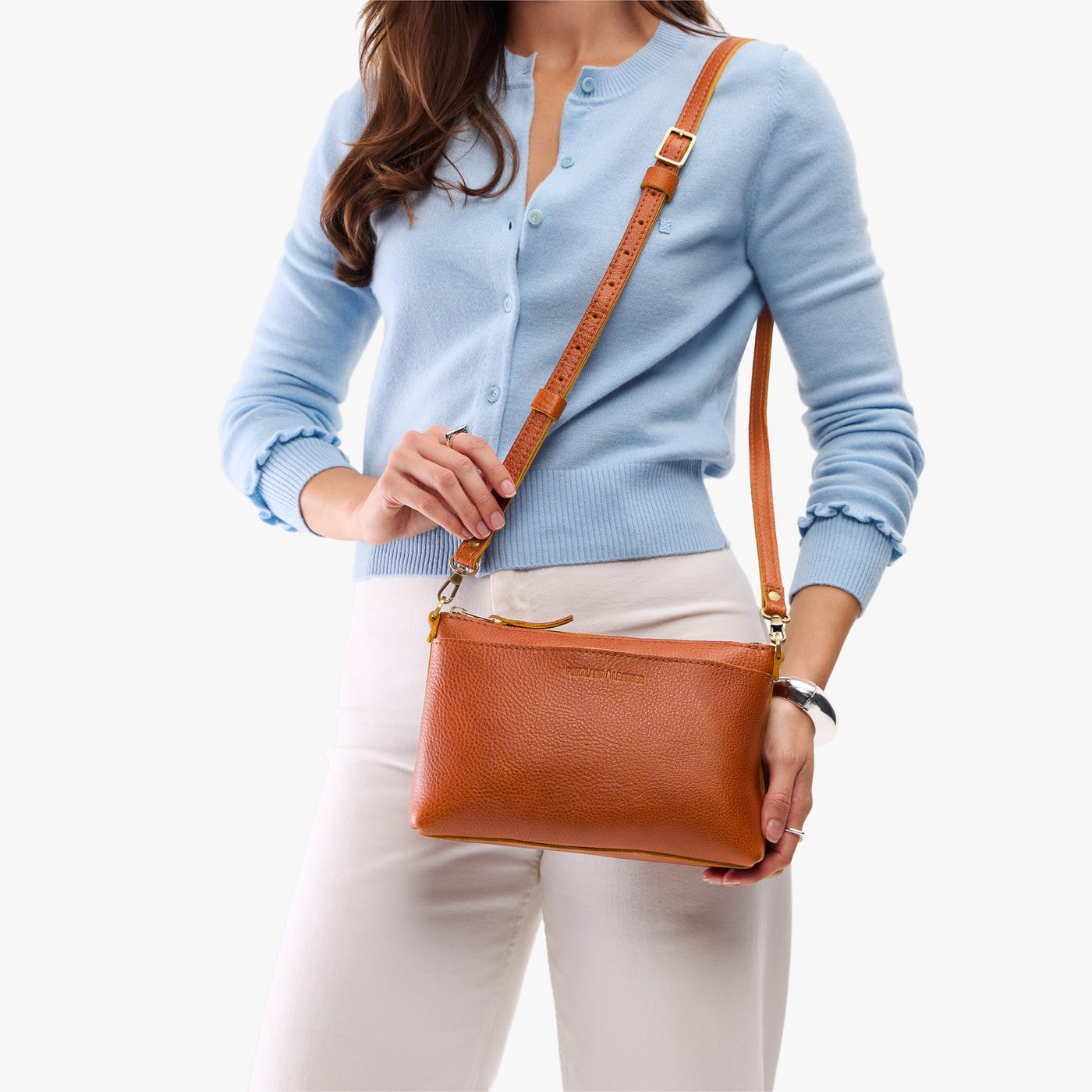 Sienna*Classic | Model holding a zip top crossbody bag with detachable strap