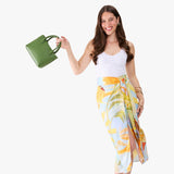 Cactus Small | Model holding a petite tote purse with structured leather handles and crossbody strap