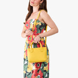 Canary Small | Model wearing a petite tote purse with structured leather handles and crossbody strap
