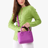Cattleya Small | Model wearing a petite tote purse with structured leather handles and crossbody strap