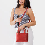 Ruby Small | Model wearing petite tote purse with structured leather handles and crossbody strap