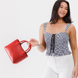 Ruby Small | Model wearing petite tote purse with structured leather handles and crossbody strap