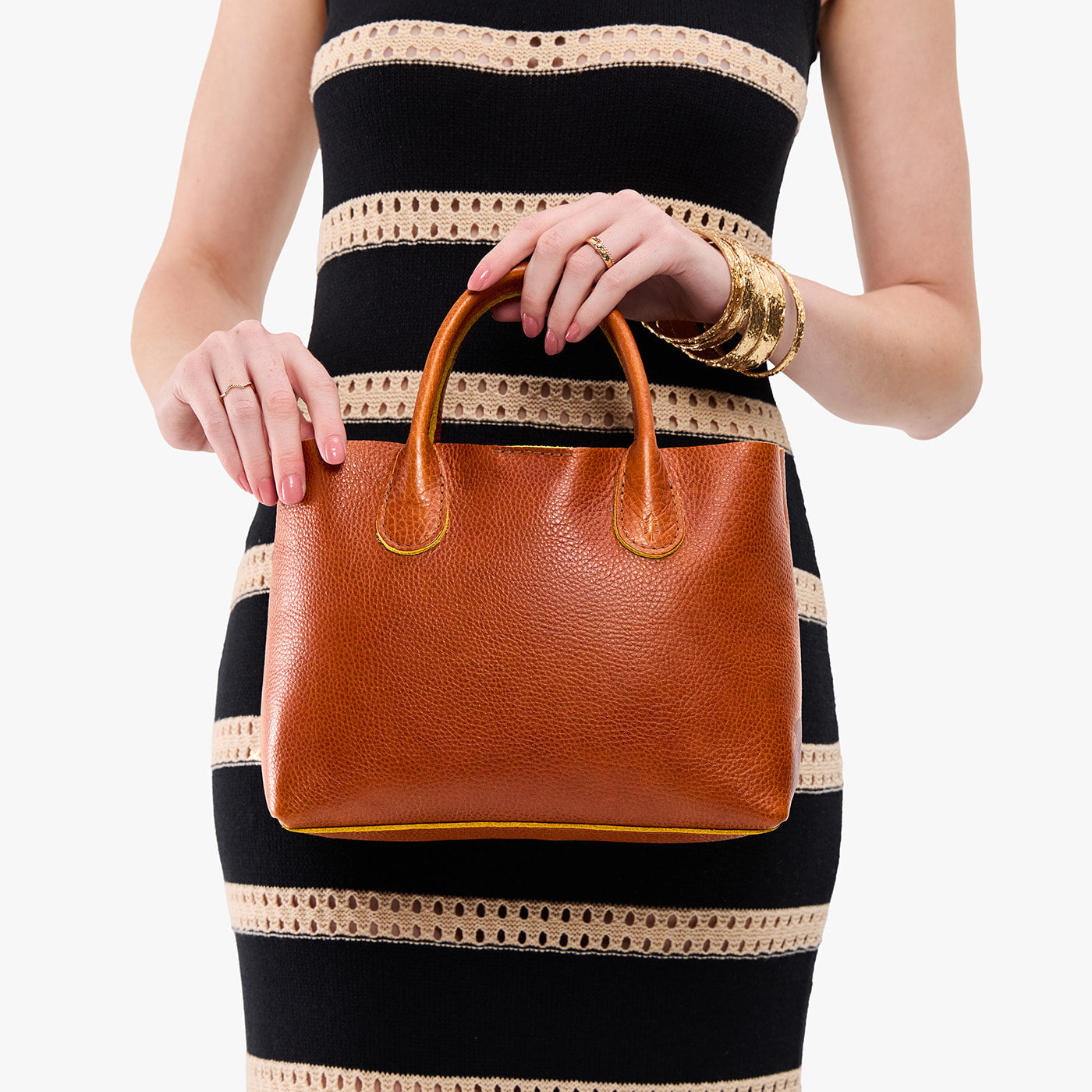 Sienna*Large | Model wearing a mid-size tote purse with  structured leather handles and crossbody strap