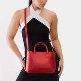 Ruby Large | Model wearing mid-size tote purse with structured leather handles and crossbody strap