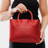 Ruby Large | Model holding mid-size tote purse with structured leather handles and crossbody strap