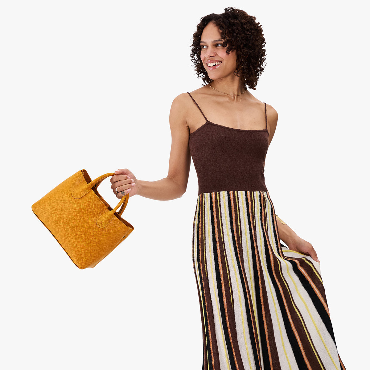 Sunshine*Large | Model wearing a mid-size tote purse with  structured leather handles and crossbody strap