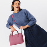 Foxglove Large | Model holding mid-size tote purse with  structured leather handles and crossbody strap