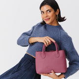 Foxglove Large | Model holding mid-size tote purse with  structured leather handles and crossbody strap
