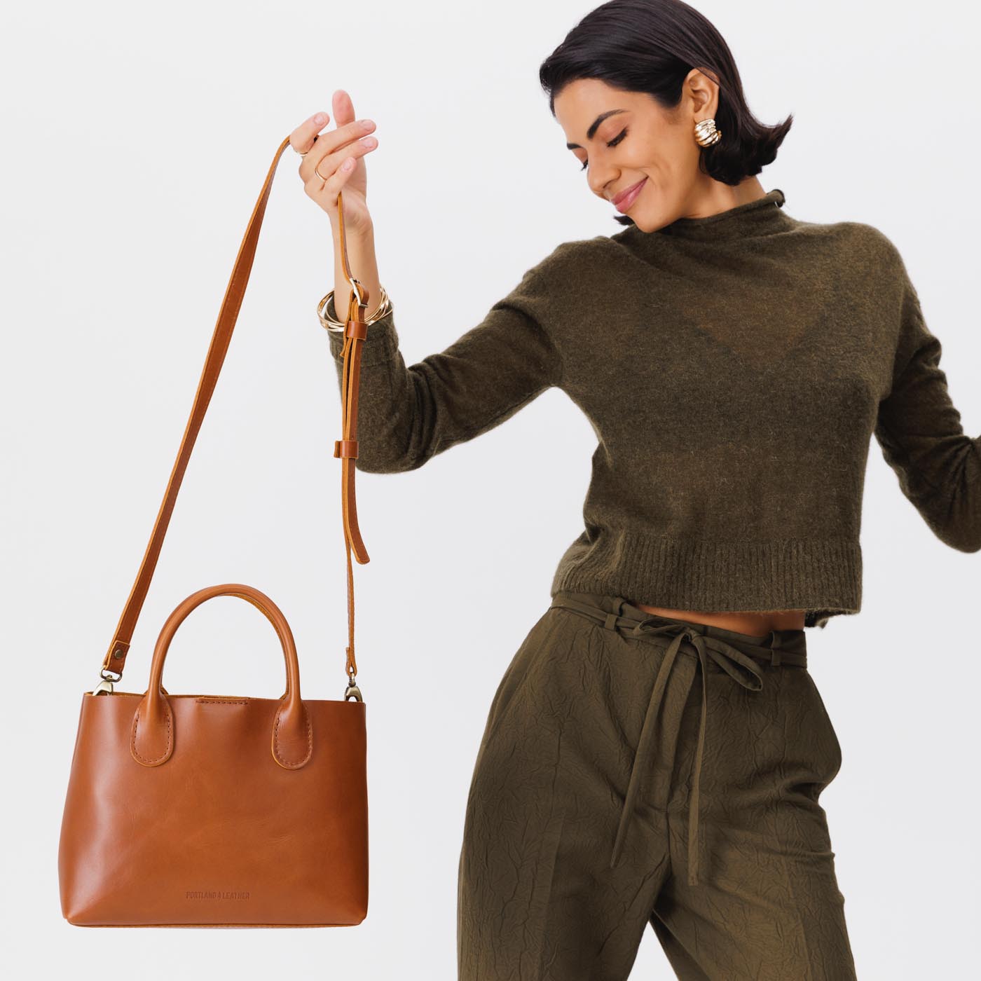 Honey*Large | Model holding mid-size tote purse with  structured leather handles and crossbody strap