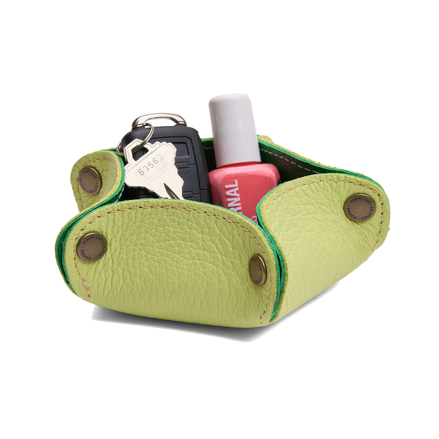 Shadow Lime | Star-shaped foldable leather tray with snap-button corners holding nail polish and car keys