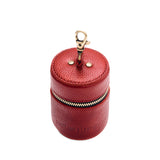 Chili Red | Cylindrical shaped pouch with a gold zipper and swivel lobster claw clasp