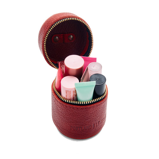 Chili Red | Cylindrical shaped pouch with a gold zipper and swivel lobster claw clasp
