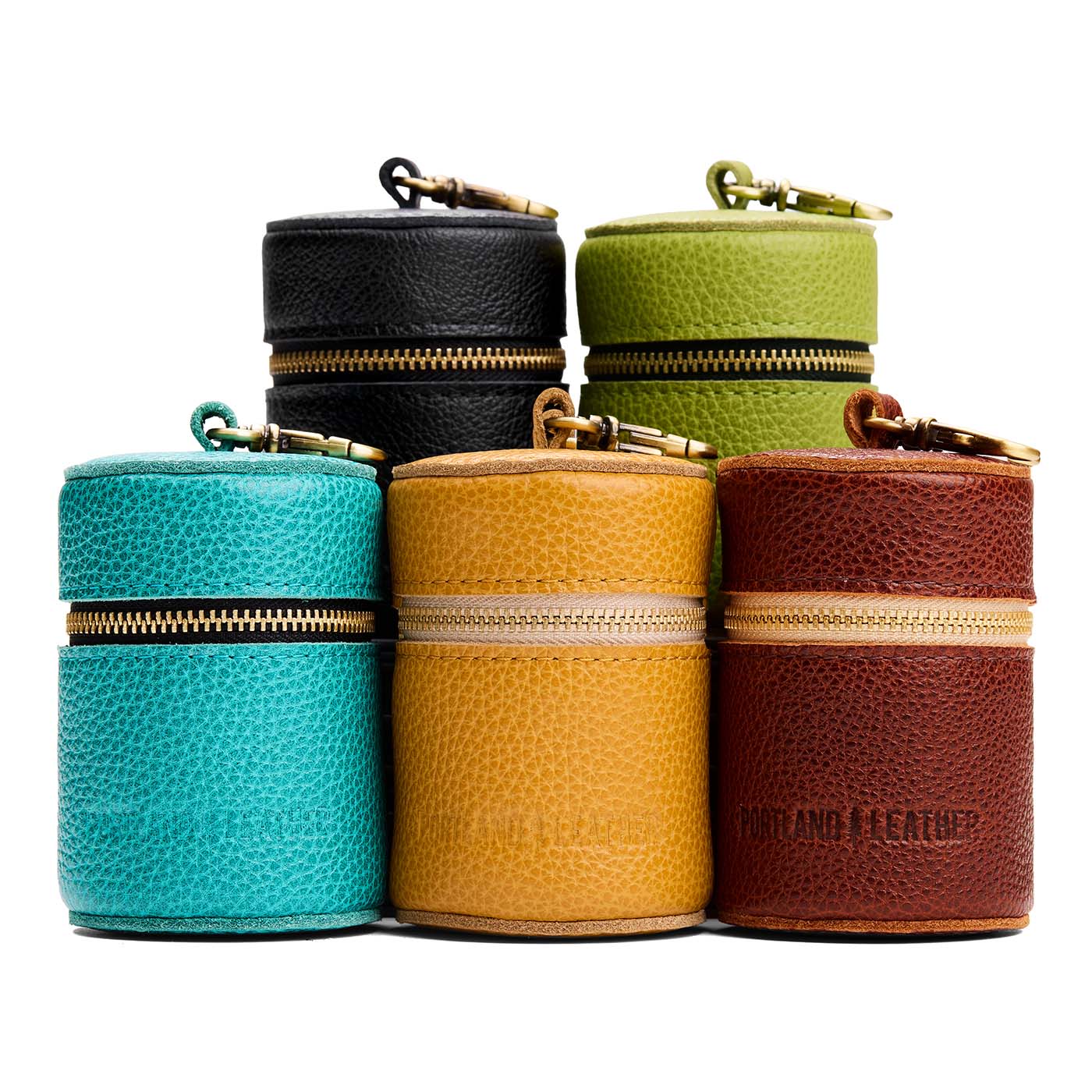 All Variants | Group of cylindrical shaped pouches with a gold zipper and swivel lobster claw clasp