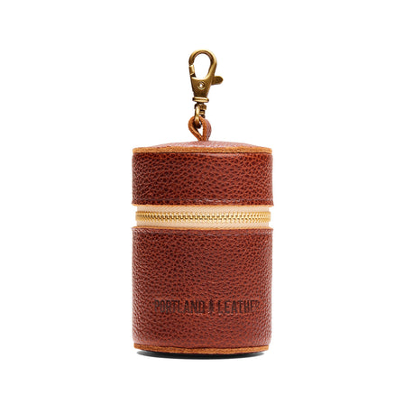 Nutmeg | Cylindrical shaped pouch with a gold zipper and swivel lobster claw clasp