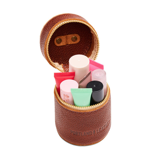 Nutmeg | Cylindrical shaped pouch with a gold zipper and swivel lobster claw clasp