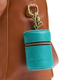 Seafoam | Cylindrical shaped pouch with a gold zipper and swivel lobster claw clasp on a bag