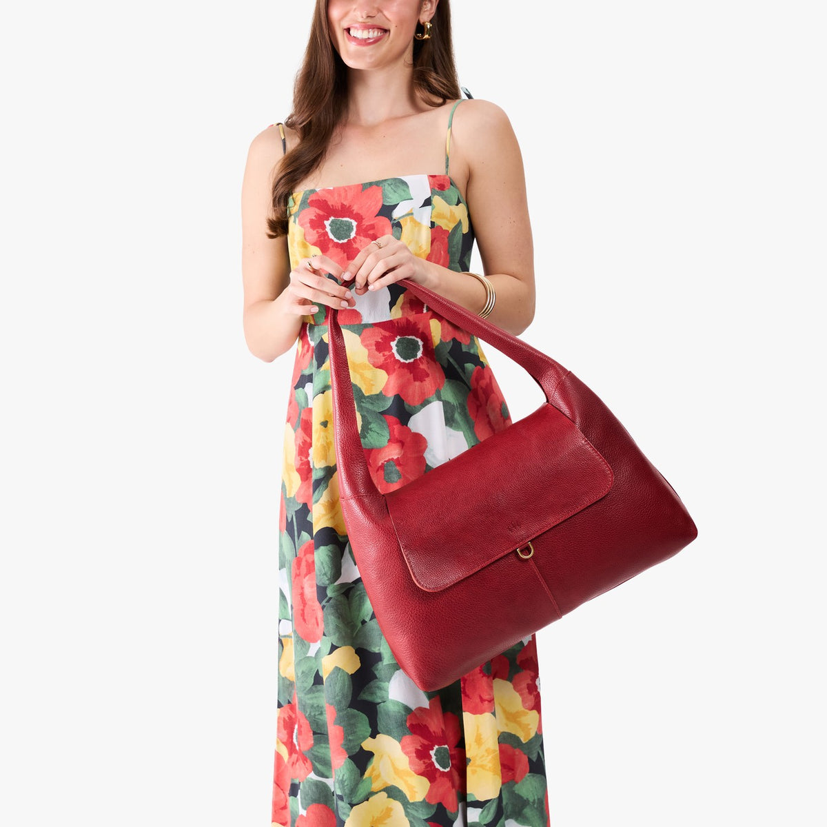 Chili Red*Large | A model holding a slouchy triangle shaped shoulder bag with a flap