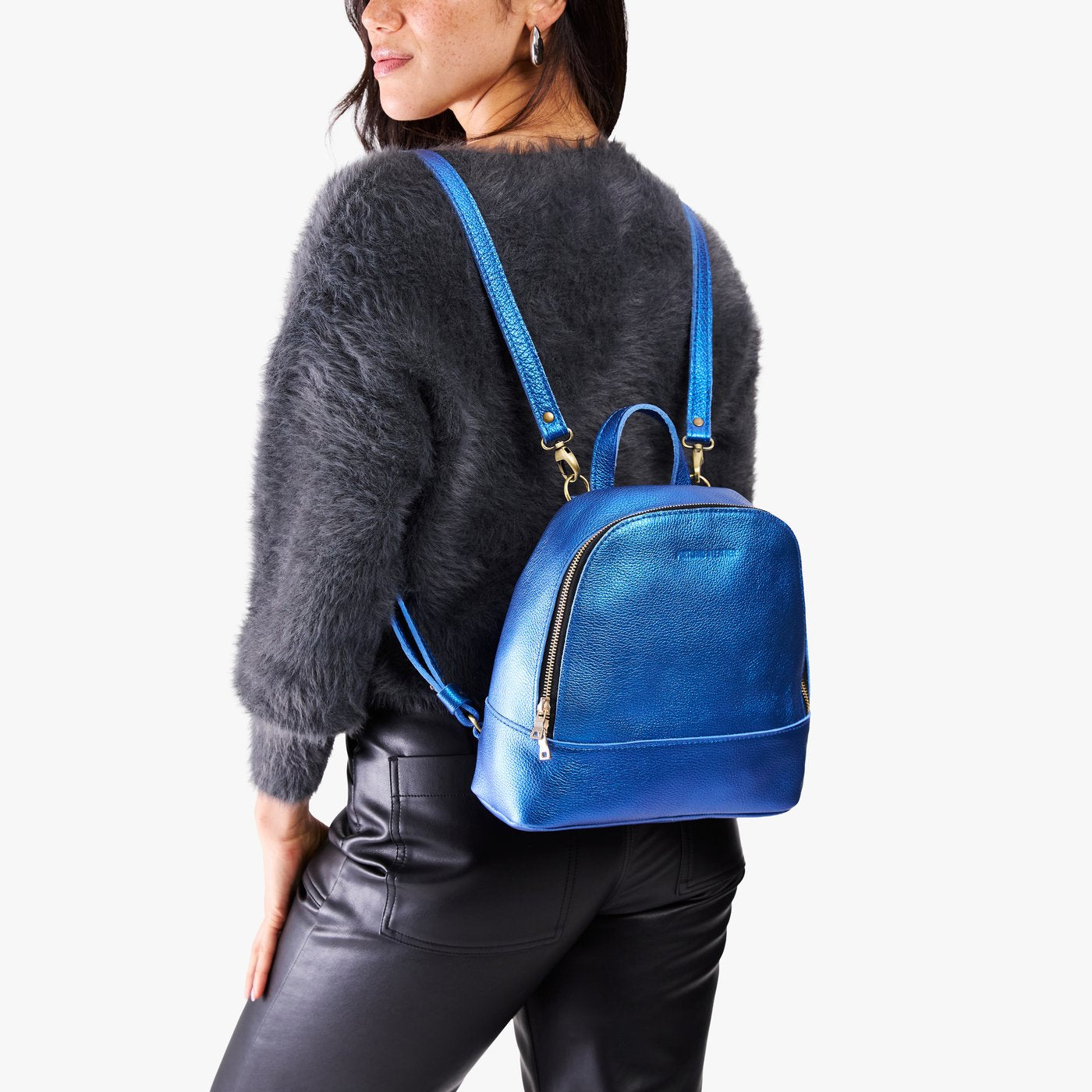 Comet Blue | Model wearing leather backpack with debossed Portland Leather logo on front