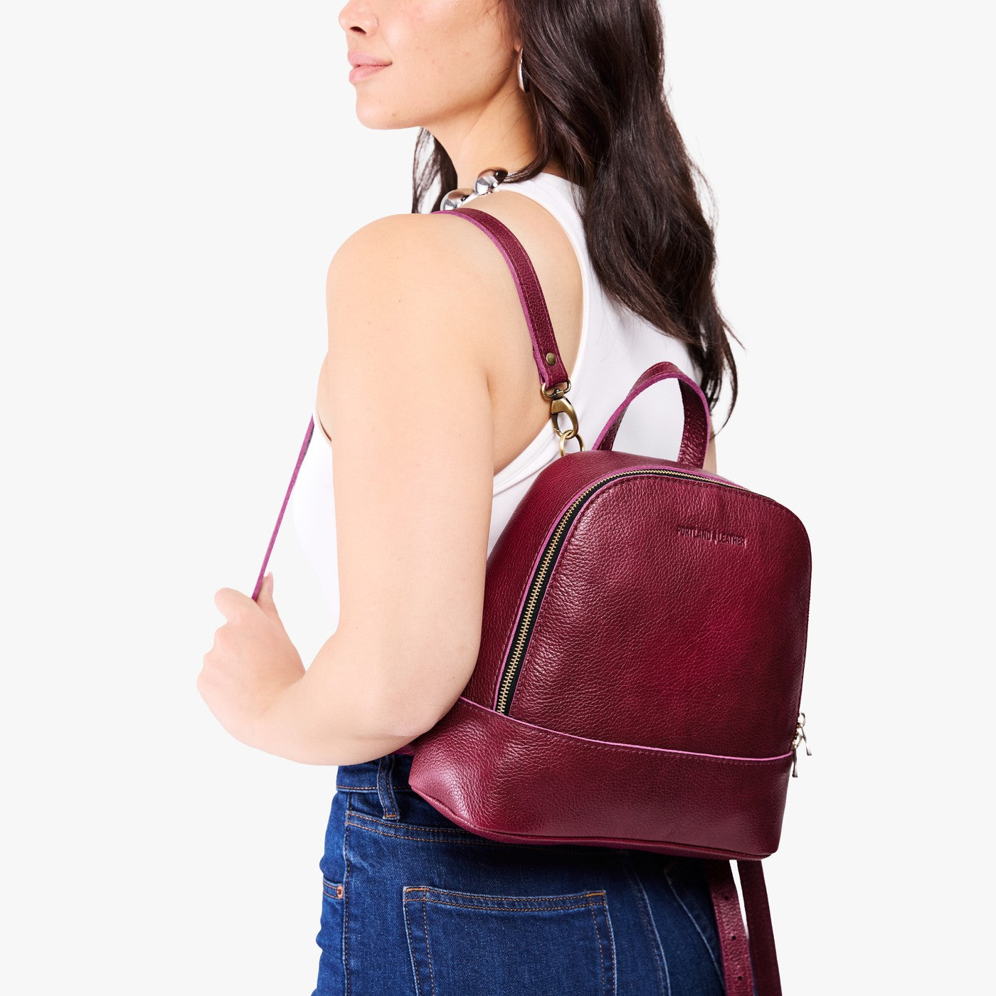 Orchid | Model wearing leather backpack with debossed Portland Leather logo on front