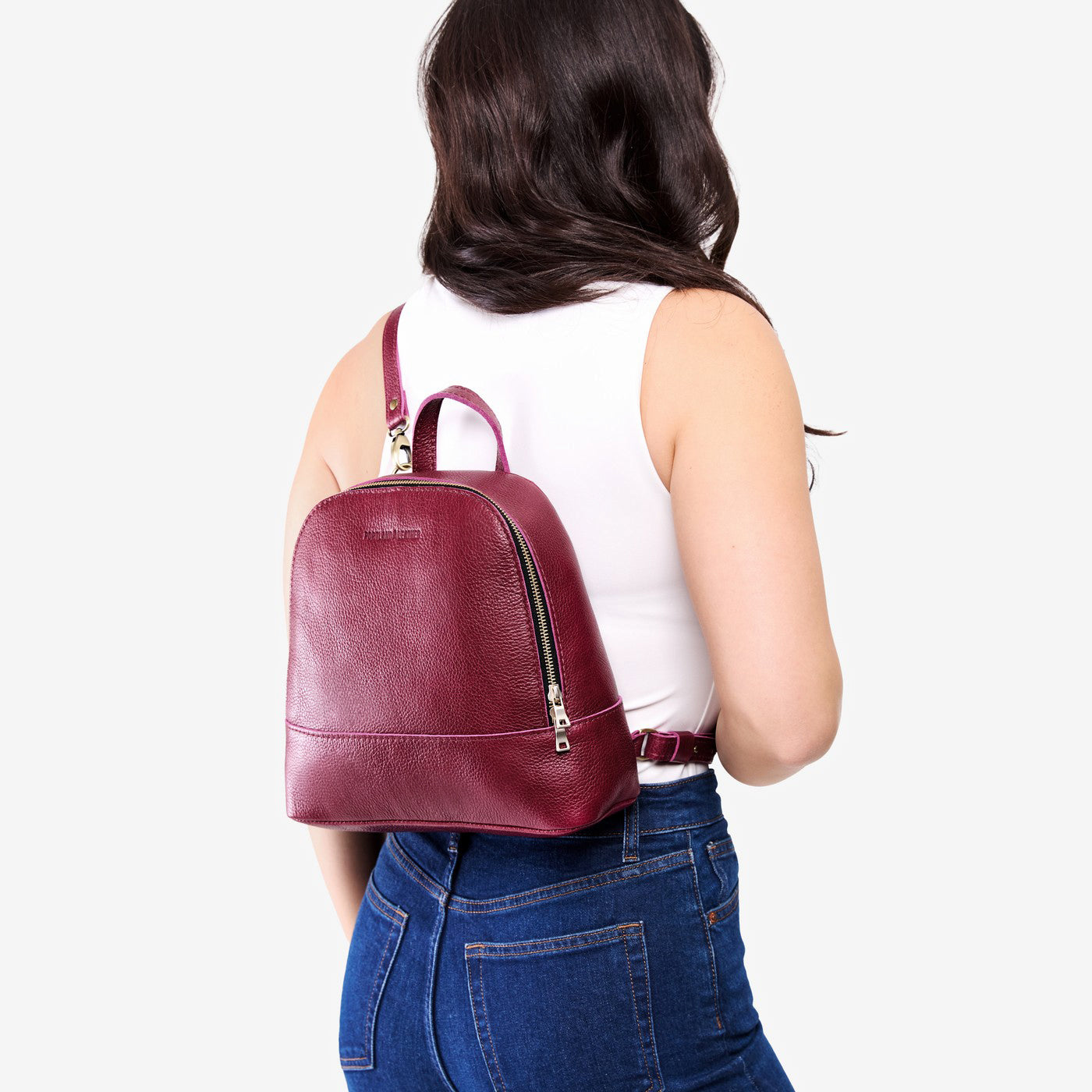 Orchid | Model wearing leather backpack sling bag style