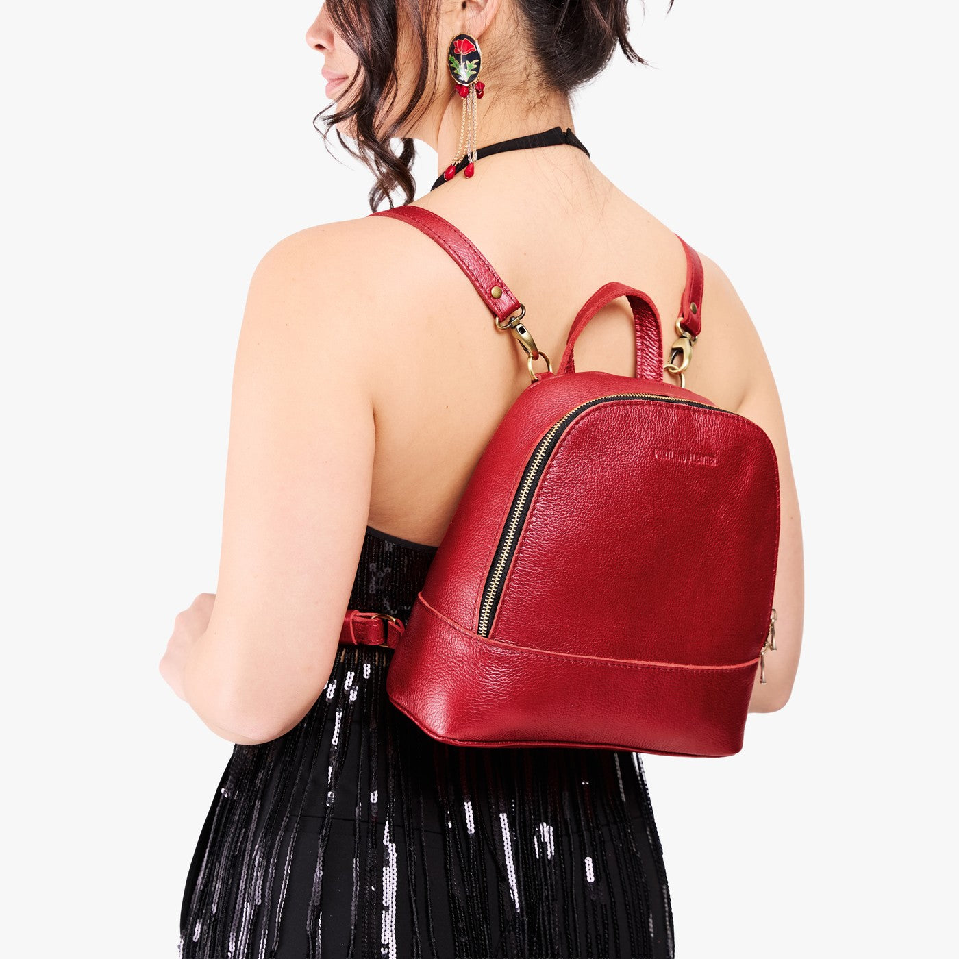 Reba Red | Model wearing leather backpack with debossed Portland Leather logo on front