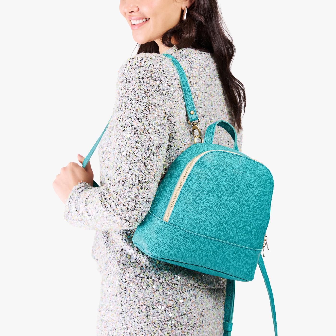 Seafoam | Model wearing leather backpack with debossed Portland Leather logo on front