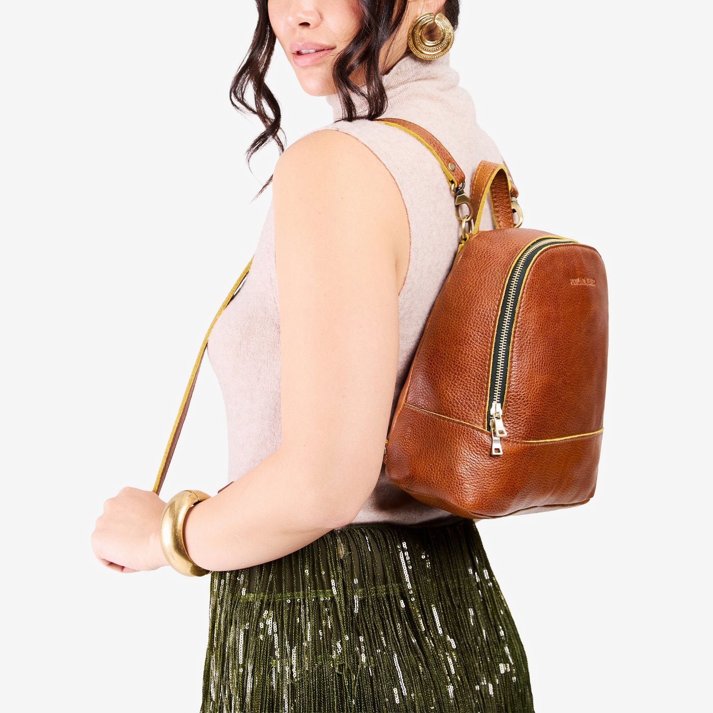 Sienna | Model wearing leather backpack with debossed Portland Leather logo on front