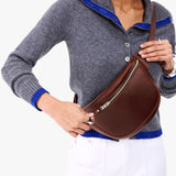Cognac | Model wearing a sling bag with front zipper