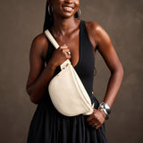 Pebbled Bone | Model wearing a sling bag with front zipper