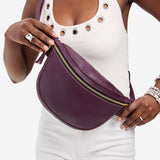 Plum | Model wearing a sling bag with front zipper