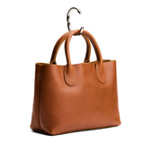 Silver | Circular metal purse hanger on a bag