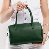 Aruba Large | Model wearing mini duffle shaped handbag with crossbody strap