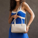 Bone Large | Model wearing mini duffle shaped handbag with crossbody strap