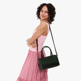 Evergreen Large | Model holding mini duffle shaped handbag with crossbody strap