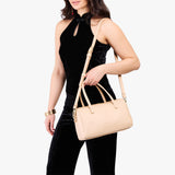 Moonflower Oversized | Model holding mini duffle shaped handbag with crossbody strap
