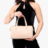 Moonflower Oversized | Model holding mini duffle shaped handbag with crossbody strap