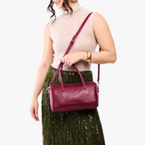 Orchid Oversized | Model holding mini duffle shaped handbag with crossbody strap