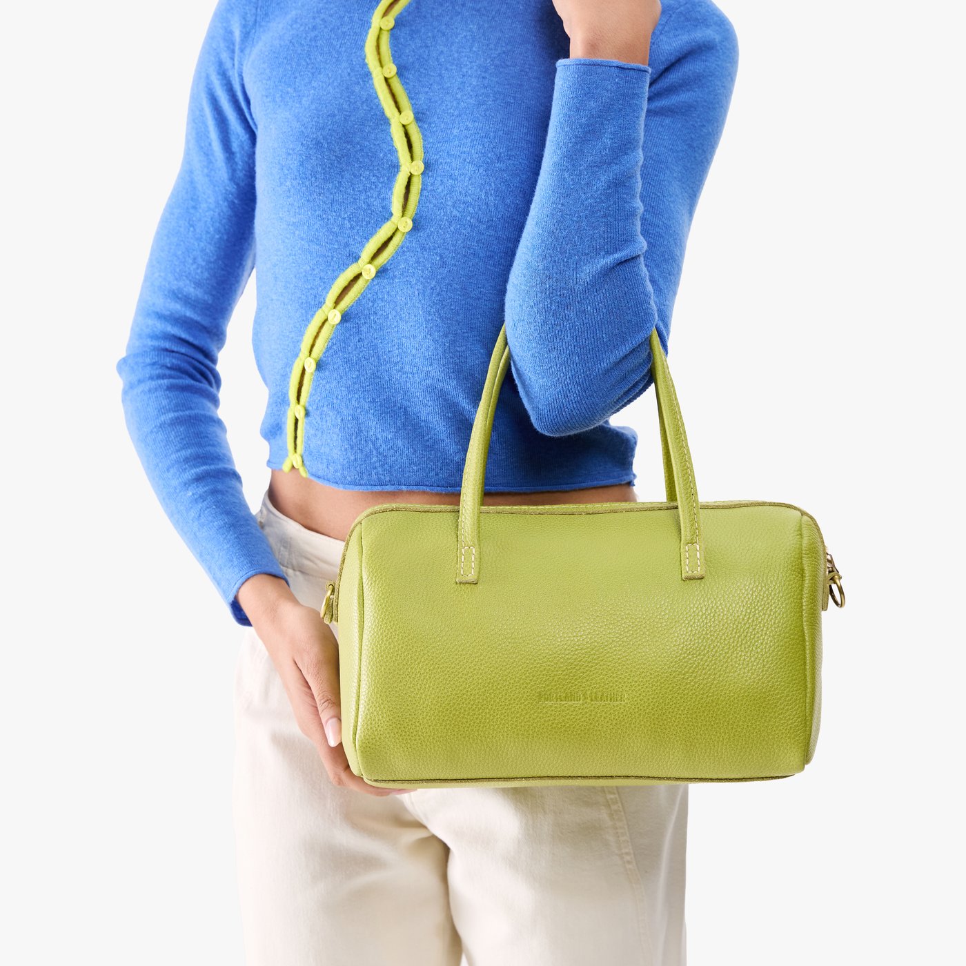 Wasabi*Oversized | Model holding mini duffle shaped handbag with crossbody strap