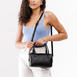 Black Small | Model wearing mini duffle shaped handbag with crossbody strap