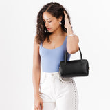 Black Small | Model wearing mini duffle shaped handbag with crossbody strap