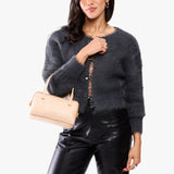 Moonflower Small | Model holding mini duffle shaped handbag with crossbody strap