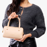 Moonflower Small | Model holding mini duffle shaped handbag with crossbody strap