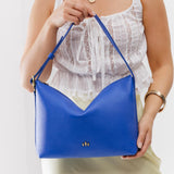Astro Blue Large | Medium sized slouchy leather shoulder bag with zipper opening and three metal tree emblems