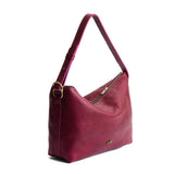 Orchid Large | Model Wearing medium sized slouchy leather shoulder bag with zipper opening and three metal tree emblems