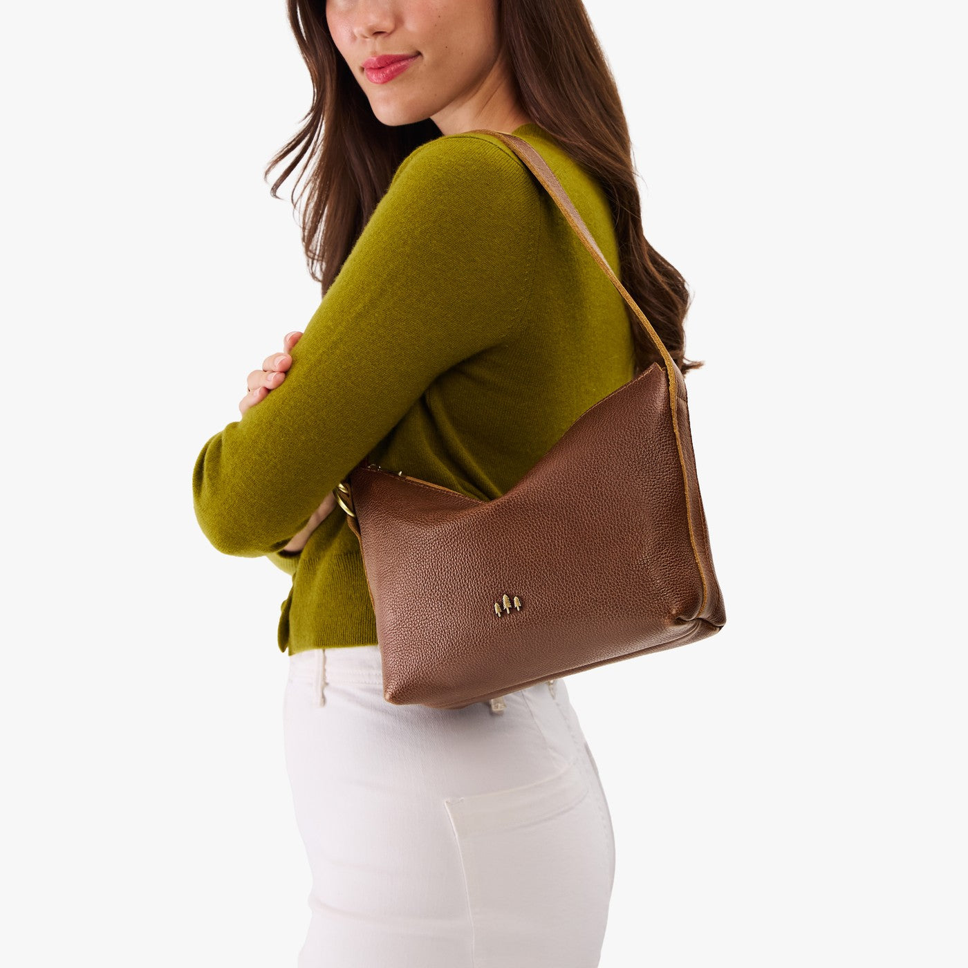 Asheville*Small | Model wearing a petite slouchy leather shoulder bag with zipper opening and three metal tree emblems